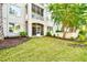 Exterior view of the property featuring a lawn, screened porch, and manicured landscaping at 2180 Waterview Dr. # 1013, North Myrtle Beach, SC 29582