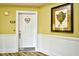 Hallway with white wainscoting, warm paint, and stylish decorations at 2180 Waterview Dr. # 1013, North Myrtle Beach, SC 29582