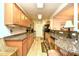 Well-lit kitchen with granite countertops, wood cabinetry, and modern appliances at 2180 Waterview Dr. # 1013, North Myrtle Beach, SC 29582