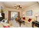 Comfortable living room features neutral tones, ceiling fan, and sliding glass doors for natural light at 2180 Waterview Dr. # 1013, North Myrtle Beach, SC 29582