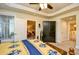 Bedroom featuring a ceiling fan, connecting doors, and a view into the living room at 2180 Waterview Dr. # 1013, North Myrtle Beach, SC 29582