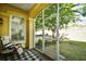 Relaxing screened porch featuring comfortable seating and view of a lush, fenced backyard at 2180 Waterview Dr. # 1013, North Myrtle Beach, SC 29582