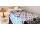 Comfortable bedroom with a decorative quilt, a bedside lamp, and a side table at 219 Birdie Way, Longs, SC 29568