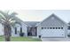 Charming single-story home with a well-maintained lawn, palm tree, and welcoming entrance at 219 Birdie Way, Longs, SC 29568