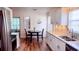 Eat-in kitchen featuring white cabinets, granite countertops, stainless steel appliances, and a small dining table at 219 Birdie Way, Longs, SC 29568