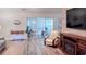Bright living room featuring light wood floors, a fireplace, and a sliding glass door at 219 Birdie Way, Longs, SC 29568
