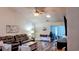 Spacious living room with wood floors, vaulted ceiling, large sofa, and access to the patio at 219 Birdie Way, Longs, SC 29568