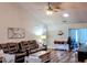 Bright and airy living room with a plush couch, fan, recessed lights and a solatube for natural light at 219 Birdie Way, Longs, SC 29568