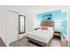 Stylishly decorated bedroom with light blue accent wall, a comfortable queen sized bed, and storage at 2311 S Ocean Blvd. # 341, Myrtle Beach, SC 29577