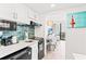 Well-equipped kitchen with modern appliances and a view into the dining area at 2311 S Ocean Blvd. # 341, Myrtle Beach, SC 29577