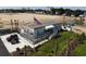 Modern building with an American flag, manicured landscaping, and parking in a developing area at 235 Fins Up Circle # 1-102, Myrtle Beach, SC 29572