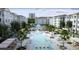 Expansive pool area surrounded by lounge chairs, umbrellas, lush landscaping, and a decorative fountain at 235 Fins Up Circle # 1-102, Myrtle Beach, SC 29572