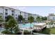 View of the community pool with lounge chairs and modern condo buildings at 235 Fins Up Circle # 1-104, Myrtle Beach, SC 29572