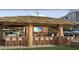 Outdoor tiki bar near the pool with chairs, TV, and thatched roof at 235 Fins Up Circle # 1-104, Myrtle Beach, SC 29572