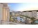 View from a balcony shows a gorgeous pool with sun loungers and buildings at 235 Fins Up Circle # 1-305, Myrtle Beach, SC 29572