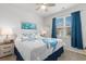 Bedroom featuring a bed with blue covers, side table, and large window at 2438 Polaris Path, Myrtle Beach, SC 29577