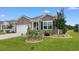 Beautiful front exterior with lush landscaping, manicured lawn and a two-car garage at 2438 Polaris Path, Myrtle Beach, SC 29577