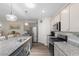 Bright kitchen with stainless steel appliances, gray cabinets, and a granite island, perfect for cooking and entertaining at 2438 Polaris Path, Myrtle Beach, SC 29577
