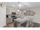 Modern kitchen with stainless steel appliances, gray cabinets, and a granite island, ideal for cooking and entertaining guests at 2438 Polaris Path, Myrtle Beach, SC 29577
