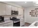 Well-equipped kitchen with stainless steel appliances, granite countertops, and a Gathering photo wall, blending functionality and style at 2438 Polaris Path, Myrtle Beach, SC 29577
