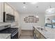 Spacious kitchen with granite countertops, stainless steel appliances, and a Gathering photo wall, blending style and comfort at 2438 Polaris Path, Myrtle Beach, SC 29577