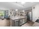 Open-concept kitchen and dining area, featuring a granite island and stainless steel appliances, creating a social atmosphere at 2438 Polaris Path, Myrtle Beach, SC 29577