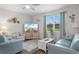 Bright living room with wood floors, comfortable sofas, and a large window at 2438 Polaris Path, Myrtle Beach, SC 29577