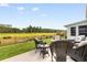 Outdoor patio with seating and a view of the lush backyard with a pond at 2438 Polaris Path, Myrtle Beach, SC 29577