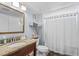 Well-lit bathroom featuring a granite vanity, framed mirror, and a shower with a curtain at 2504 N Ocean Blvd. # 1936, Myrtle Beach, SC 29577