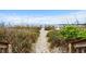 Sandy path leading to the beach, surrounded by dunes and beach vegetation at 2504 N Ocean Blvd. # 1936, Myrtle Beach, SC 29577