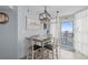 Cozy dining area with a table for four, featuring a unique light fixture and access to the balcony at 2504 N Ocean Blvd. # 1936, Myrtle Beach, SC 29577