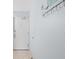 Neutral hallway featuring tile floors, white door and a coat rack at 2504 N Ocean Blvd. # 1936, Myrtle Beach, SC 29577