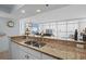 Open kitchen featuring granite countertops, a stainless steel sink, and a breakfast bar overlooking the living area at 2504 N Ocean Blvd. # 1936, Myrtle Beach, SC 29577