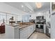 Well-lit kitchen featuring granite countertops, stainless steel appliances, and breakfast bar at 2504 N Ocean Blvd. # 1936, Myrtle Beach, SC 29577