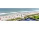 Stunning aerial shot of a sandy beach with colorful umbrellas and people enjoying the ocean and sunshine, perfect for vacation vibes at 2504 N Ocean Blvd. # 936, Myrtle Beach, SC 29577