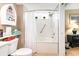 This bathroom features a shower and bath combo with white tiling and a boat-shaped shelf at 2504 N Ocean Blvd. # 936, Myrtle Beach, SC 29577