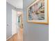 Hallway featuring wood flooring and artwork; view into the kitchen at 2504 N Ocean Blvd. # 936, Myrtle Beach, SC 29577