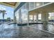 Comfortable indoor pool area offering shallow water, palm trees, and various poolside seating, perfect for vacationing at 2504 N Ocean Blvd. # 936, Myrtle Beach, SC 29577
