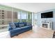Bright living room features floor-to-ceiling windows, comfortable seating and modern fireplace at 2504 N Ocean Blvd. # 936, Myrtle Beach, SC 29577