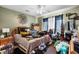 A light-filled bedroom features neutral walls, ceiling fan, and large window, though contents display clutter at 2611 Ringneck Trail, Myrtle Beach, SC 29588