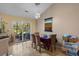 A well-lit dining room featuring a table with seating for six, a chandelier, and sliding glass doors to a patio at 2611 Ringneck Trail, Myrtle Beach, SC 29588