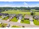 An aerial shot of a neighborhood with a golf course and pond in the background on a sunny day at 2783 Sanctuary Blvd., Conway, SC 29526