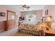 Bright bedroom with floral bedding, ample storage, and natural light at 2783 Sanctuary Blvd., Conway, SC 29526