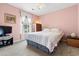 Comfortable bedroom with striped bedding, soft lighting, and pink walls at 2783 Sanctuary Blvd., Conway, SC 29526