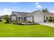 Beautiful single-story home with manicured lawn, lush landscaping and an attached two-car garage at 2783 Sanctuary Blvd., Conway, SC 29526