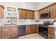 Bright kitchen features stainless steel appliances, wood cabinets, light countertops and hardwood floors at 2783 Sanctuary Blvd., Conway, SC 29526