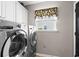 Modern laundry room featuring stainless steel washer and dryer, and window with valance at 2783 Sanctuary Blvd., Conway, SC 29526