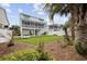 Expansive backyard featuring lush green grass, tropical palms, and a charming outdoor space for relaxation at 304 62Nd Ave N 62Nd Ave. N, North Myrtle Beach, SC 29582