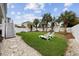 Spacious backyard with lawn, shaded by mature palm trees, and enclosed by a white picket fence at 304 62Nd Ave N 62Nd Ave. N, North Myrtle Beach, SC 29582