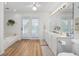 Bright bathroom featuring double sinks, garden tub, and a glass door to the backyard at 304 62Nd Ave N 62Nd Ave. N, North Myrtle Beach, SC 29582